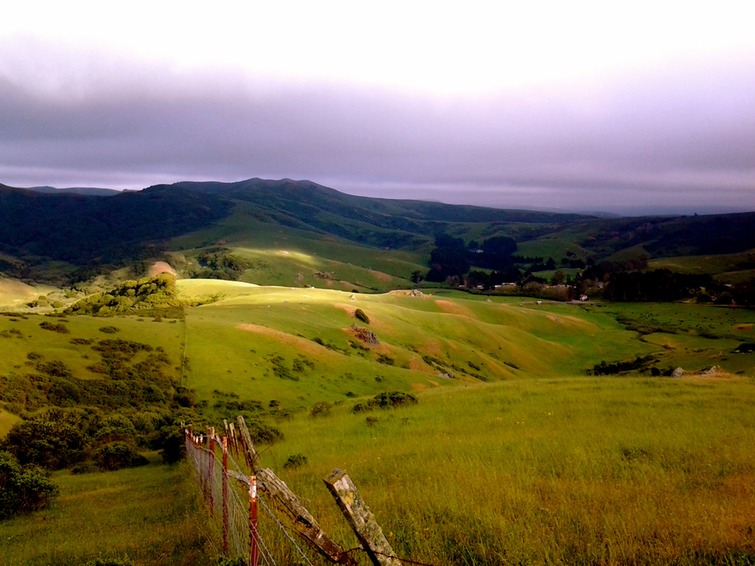 Ranch valley viewed
          from a hillside trail